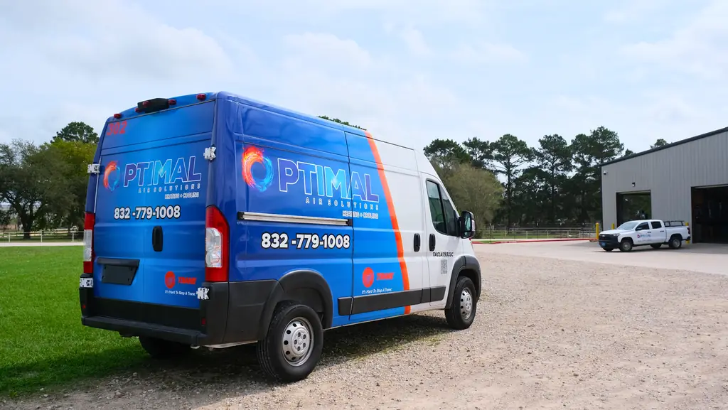 An Optimal Air Solutions van parked outside the company's own shop building in Tomball